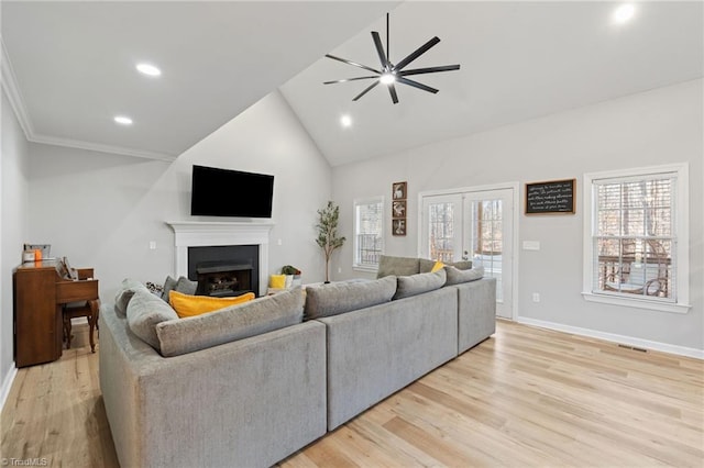 living room featuring ceiling fan, high vaulted ceiling, and light hardwood / wood-style floors