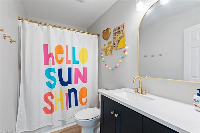 full bathroom with vanity, hardwood / wood-style flooring, toilet, and shower / bath combo with shower curtain