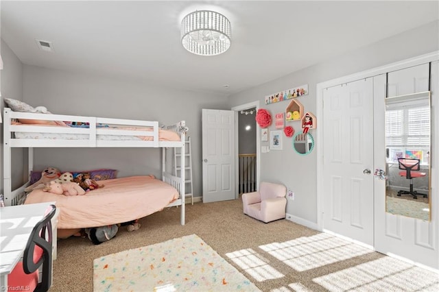 bedroom featuring light colored carpet and a closet