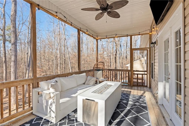 deck featuring ceiling fan, an outdoor fire pit, and french doors