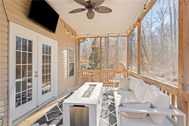 sunroom featuring ceiling fan, french doors, and wood ceiling