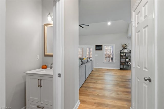 bathroom featuring vanity, hardwood / wood-style flooring, and ceiling fan