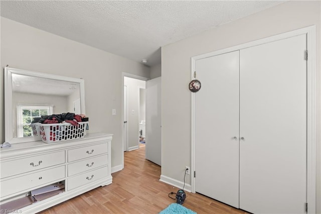 124 Jacklyn Ct, High Point, NC 27265 - bedroom featuring light wood-type flooring, a textured ceiling, a closet, and baseboards