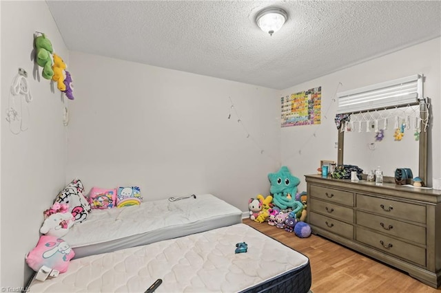 124 Jacklyn Ct, High Point, NC 27265 - bedroom featuring wood finished floors and a textured ceiling