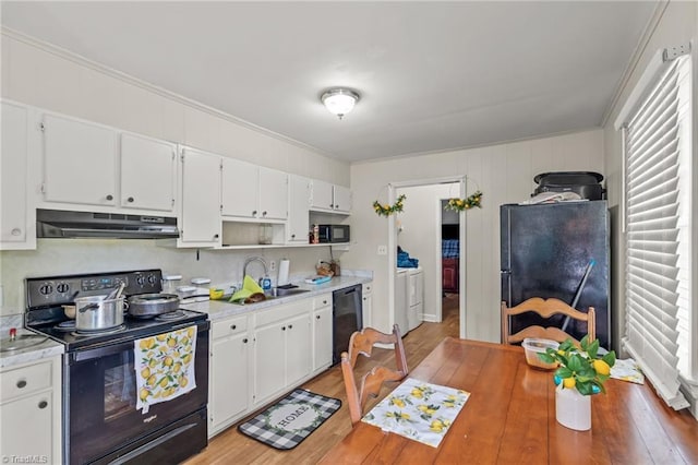124 Jacklyn Ct, High Point, NC 27265 - kitchen with black appliances, under cabinet range hood, washing machine and clothes dryer, light countertops, and a sink