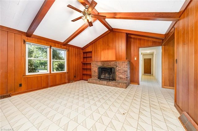 610 Frye Bridge Rd, Clemmons, NC 27012 - unfurnished living room with wooden walls, ceiling fan, built in features, and a brick fireplace