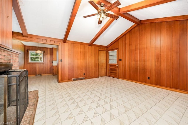 610 Frye Bridge Rd, Clemmons, NC 27012 - unfurnished living room with a ceiling fan, wood walls, and a brick fireplace