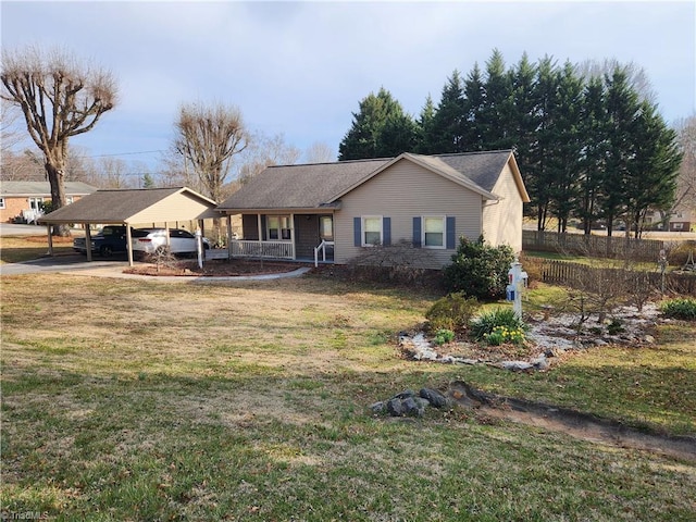 ranch-style house featuring a carport and a front lawn