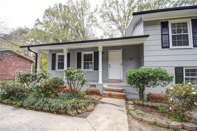 view of exterior entry featuring a porch