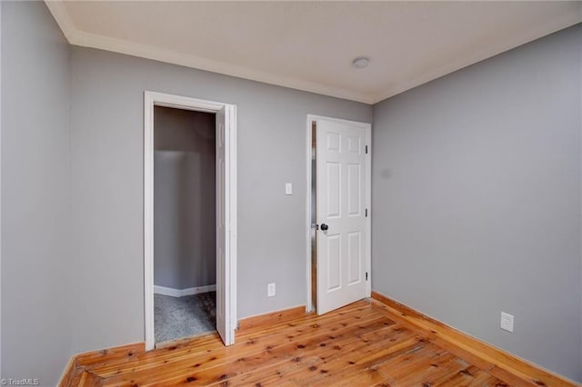 1638 Colonial Dr, Salisbury, NC 28144 - empty room with light wood-type flooring, baseboards, crown molding, and a smoke detector