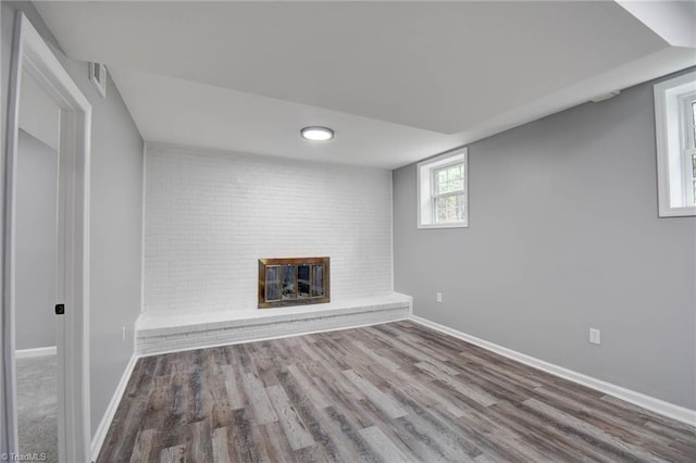 basement with a fireplace and hardwood / wood-style flooring