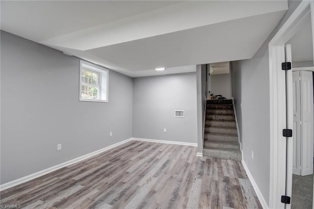 1638 Colonial Dr, Salisbury, NC 28144 - below grade area featuring wood finished floors, baseboards, and stairs