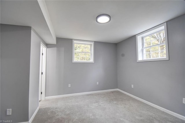 basement featuring light colored carpet