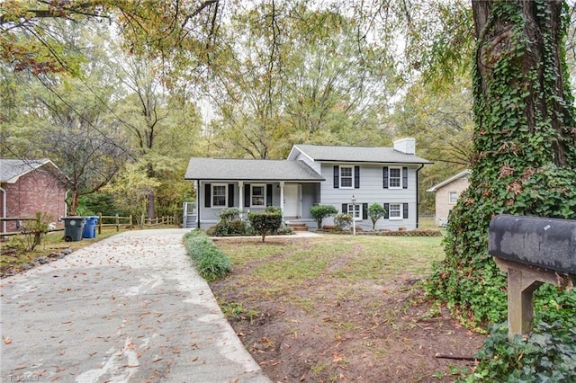 1638 Colonial Dr, Salisbury, NC 28144 - tri-level home with a porch, concrete driveway, a chimney, and a front yard