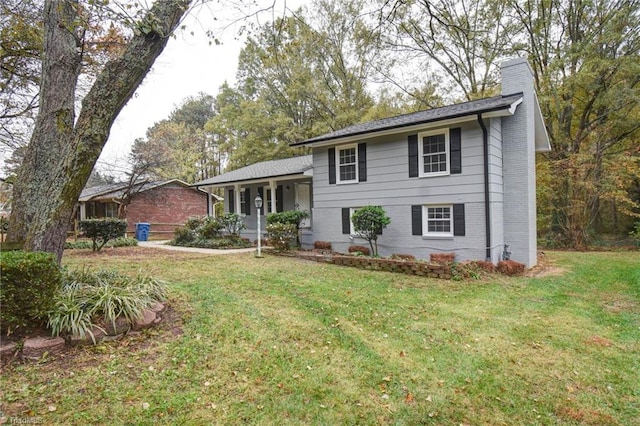 1638 Colonial Dr, Salisbury, NC 28144 - split level home with a chimney, a front yard, and brick siding