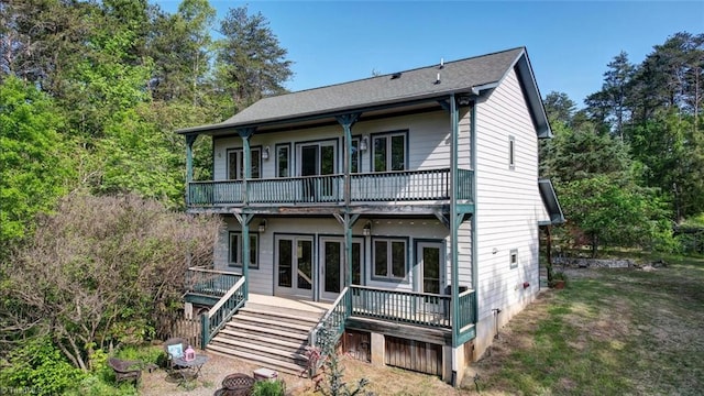 back of house with a wooden deck, stairs, and a balcony
