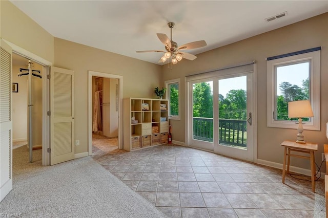 doorway to outside featuring light tile patterned floors, baseboards, a ceiling fan, and visible vents