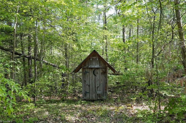view of shed featuring a wooded view