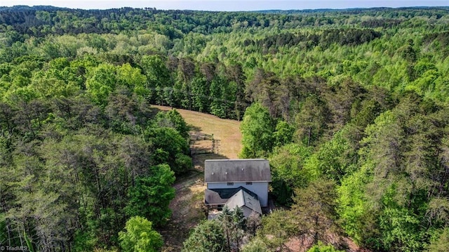 drone / aerial view with a wooded view
