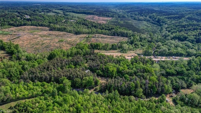 birds eye view of property with a wooded view