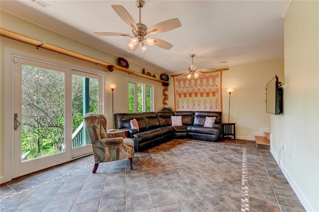 living room with baseboards, ceiling fan, tile patterned flooring, and visible vents