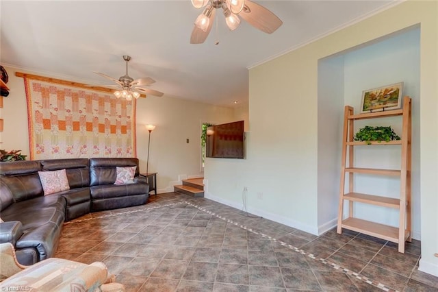 living room featuring baseboards, ornamental molding, and a ceiling fan