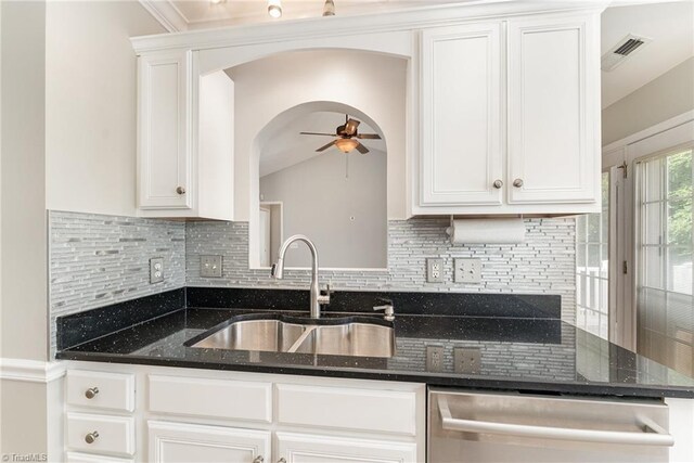 5921 Election Oak Dr, High Point, NC 27265 - kitchen with stainless steel dishwasher, a sink, ceiling fan, arched walkways, and decorative backsplash