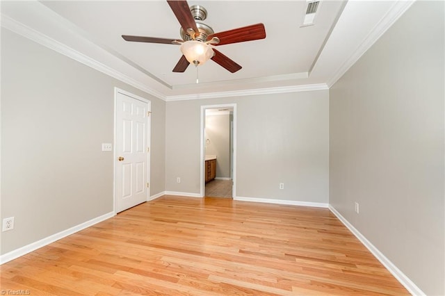 5921 Election Oak Dr, High Point, NC 27265 - spare room with light wood finished floors, a ceiling fan, baseboards, ornamental molding, and a tray ceiling