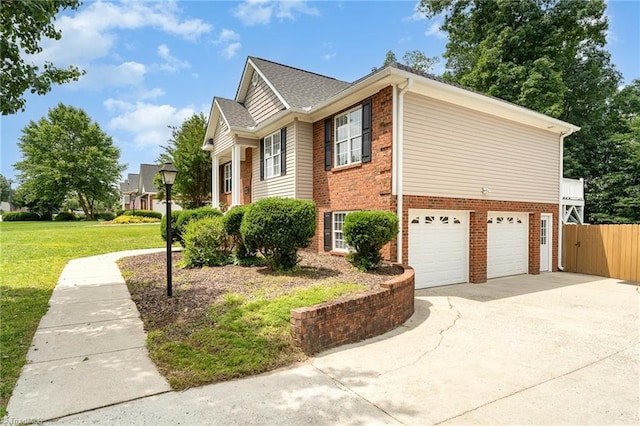 5921 Election Oak Dr, High Point, NC 27265 - view of home's exterior featuring brick siding, a garage, and concrete driveway