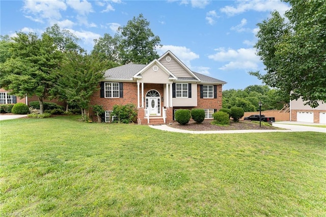 5921 Election Oak Dr, High Point, NC 27265 - bi-level home featuring brick siding, a front yard, a garage, and concrete driveway