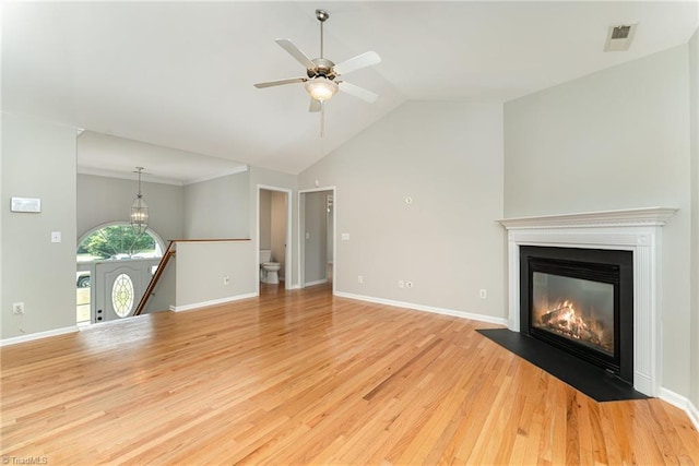 5921 Election Oak Dr, High Point, NC 27265 - unfurnished living room with light wood-style flooring, a ceiling fan, a fireplace with flush hearth, baseboards, and high vaulted ceiling