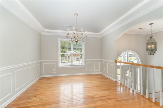 5921 Election Oak Dr, High Point, NC 27265 - unfurnished room featuring a chandelier, light wood finished floors, arched walkways, a wainscoted wall, and ornamental molding