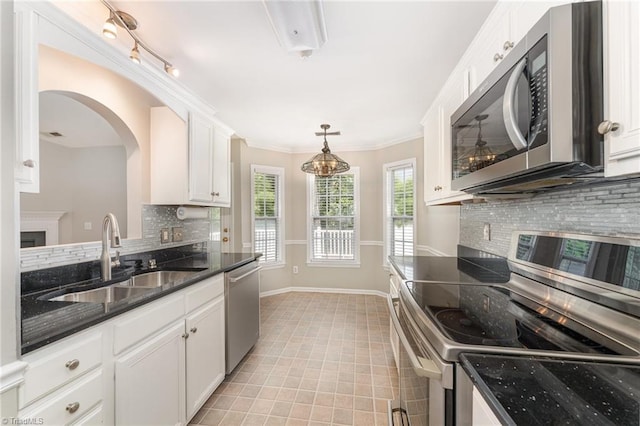 5921 Election Oak Dr, High Point, NC 27265 - kitchen featuring stainless steel appliances, a sink, white cabinetry, backsplash, and light tile patterned flooring