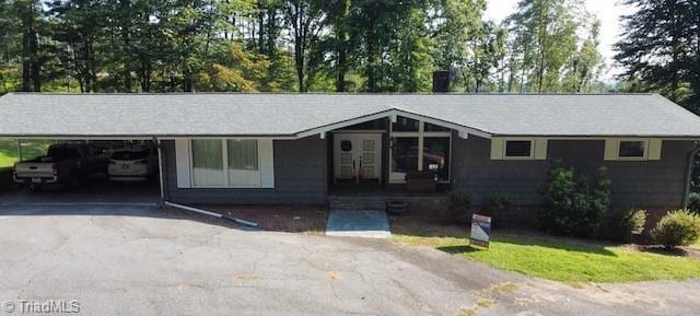 ranch-style house featuring a carport