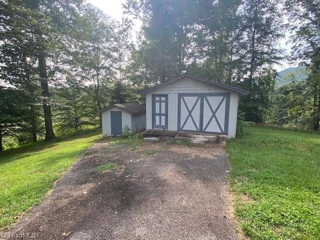 view of outbuilding with a lawn