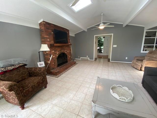 living room featuring ornamental molding, a fireplace, lofted ceiling with beams, and ceiling fan