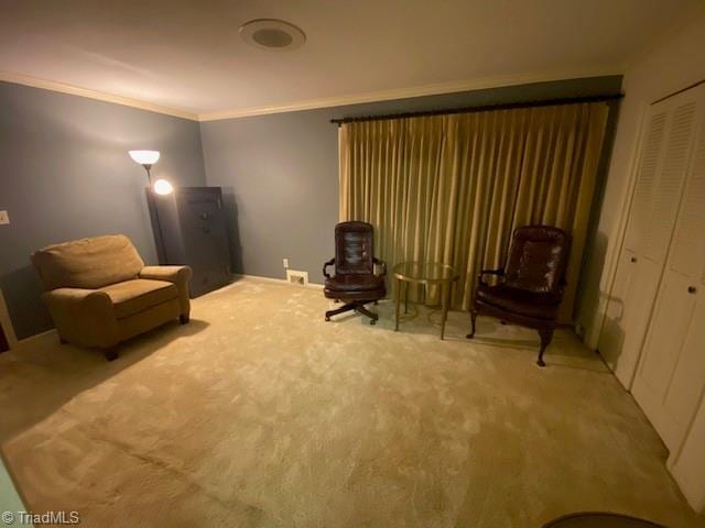 sitting room featuring ornamental molding, carpet, and baseboards