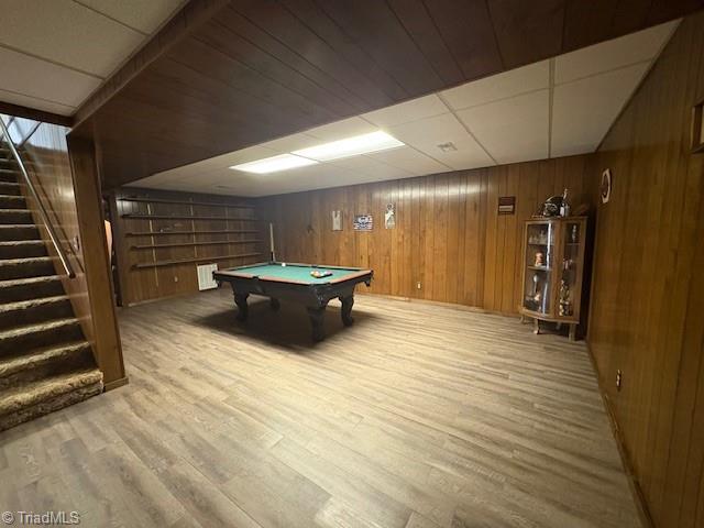 game room with wooden walls, wood finished floors, and pool table