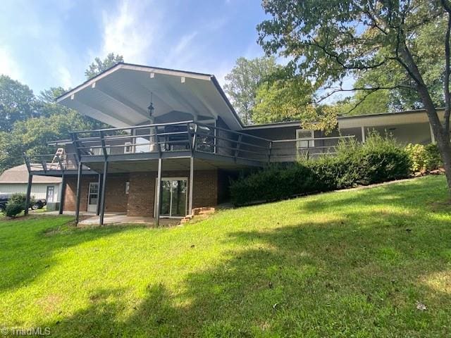 back of house with a deck and a lawn