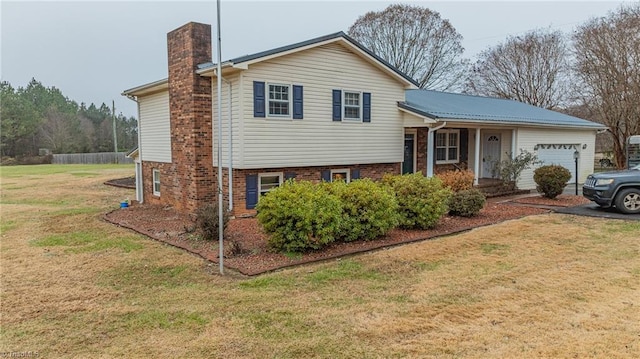 split level home featuring a front lawn and a garage