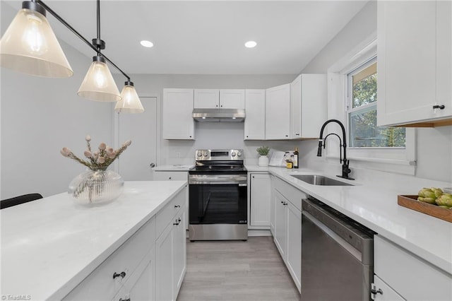 kitchen with white cabinetry, stainless steel appliances, and sink