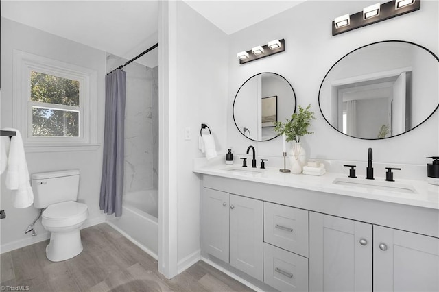 full bathroom with vanity, shower / bath combination with curtain, wood-type flooring, and toilet