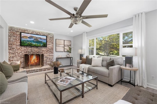 living room with hardwood / wood-style flooring, a fireplace, and ceiling fan