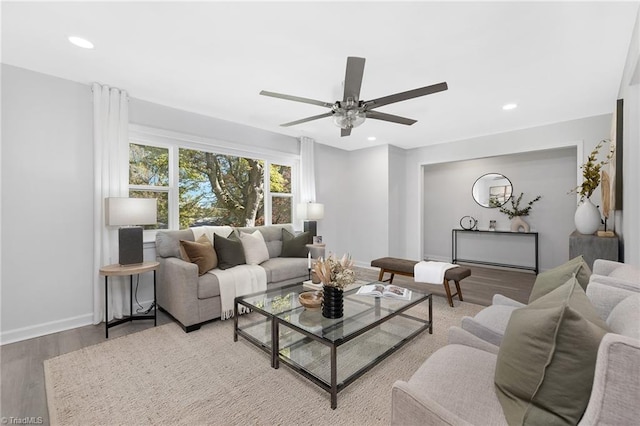 living room featuring hardwood / wood-style floors and ceiling fan