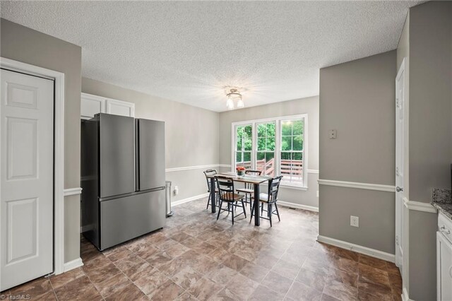 7145 Franklin Rd, Lewisville, NC 27023 - dining area featuring a textured ceiling and baseboards