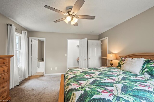 7145 Franklin Rd, Lewisville, NC 27023 - bedroom featuring light colored carpet, ensuite bath, a ceiling fan, and a closet