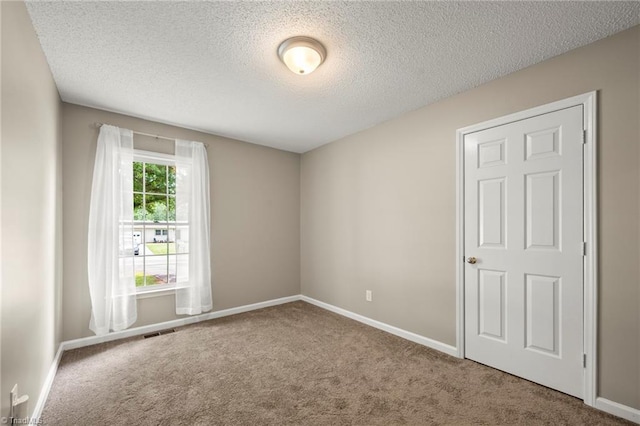 7145 Franklin Rd, Lewisville, NC 27023 - unfurnished room with carpet floors and a textured ceiling