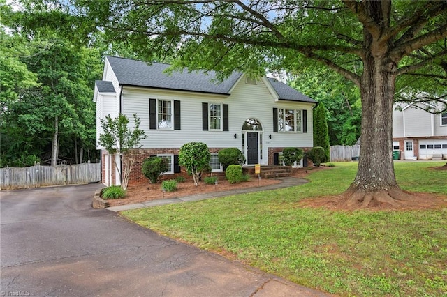 7145 Franklin Rd, Lewisville, NC 27023 - split foyer home with asphalt driveway, an attached garage, brick siding, and a shingled roof