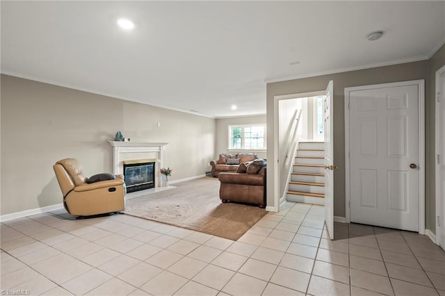 7145 Franklin Rd, Lewisville, NC 27023 - living room featuring crown molding, a fireplace with flush hearth, light tile patterned floors, stairway, and light carpet