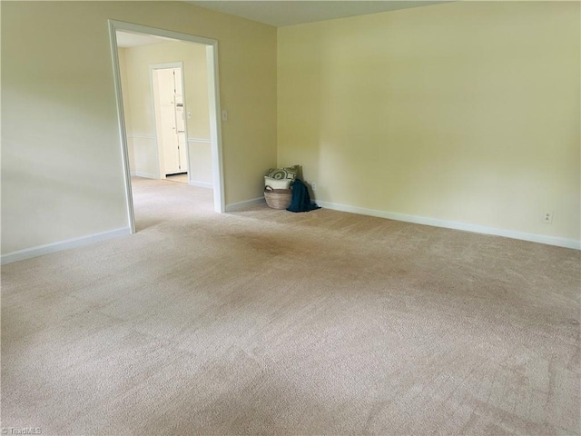 carpeted spare room with baseboards